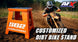 Person riding a dirt bike next to an orange 562 Arredondo stand with AFX Motorsports logo.